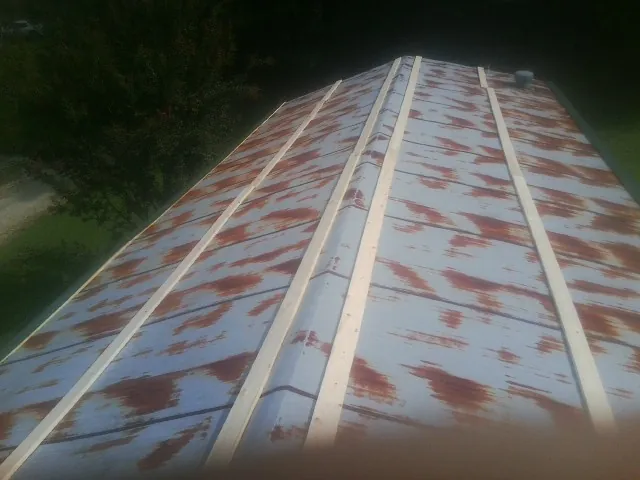 Rusted metal roof panels with new wood purlins before replacement — Storm Damage Roof Repair in Flemington by Roofing Brothers